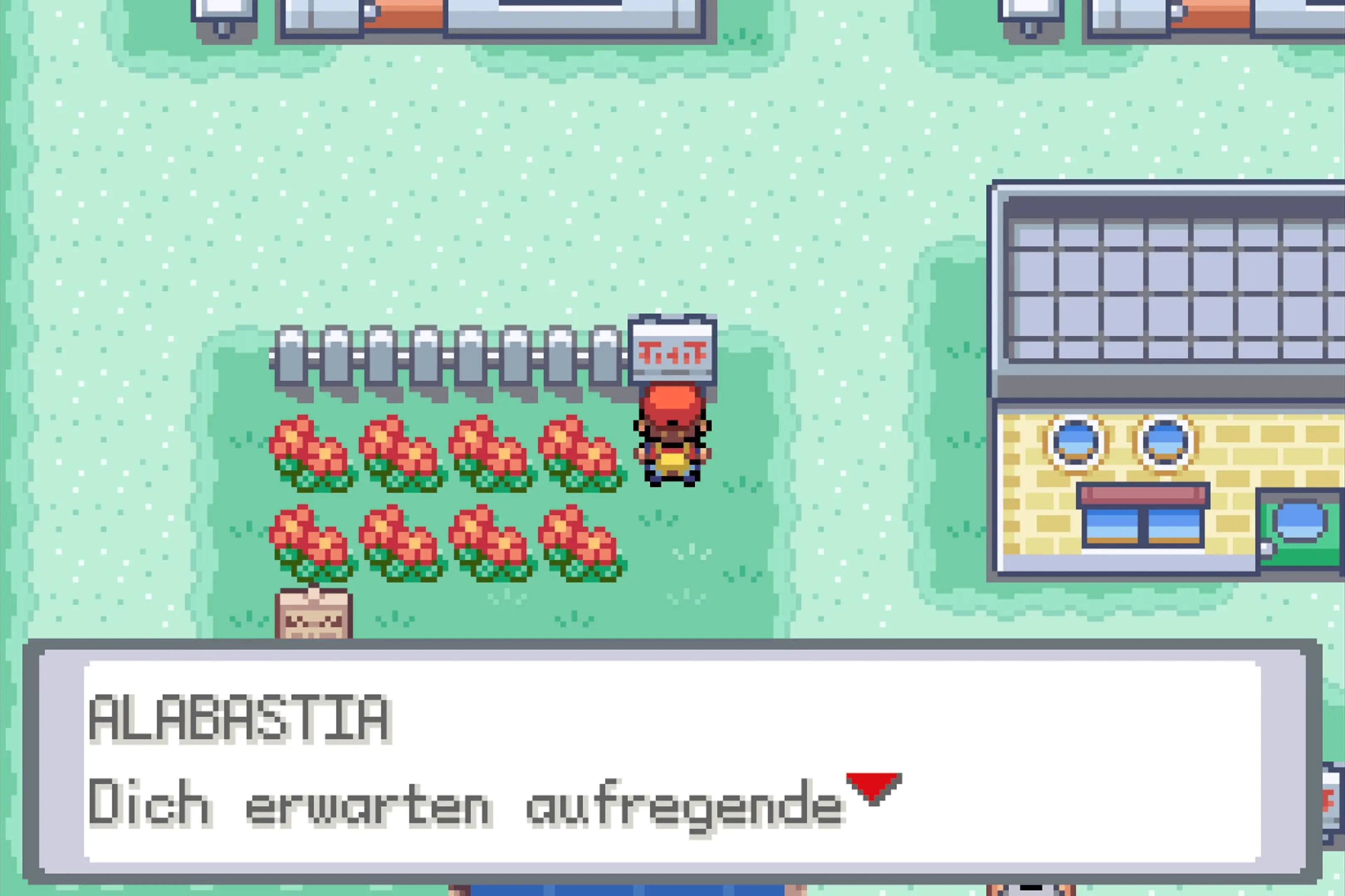 Draufsicht auf Stadt Alabastia mit Spielfigur neben einem Blumenbeet. Textbox: „Dich erwarten aufregende…"